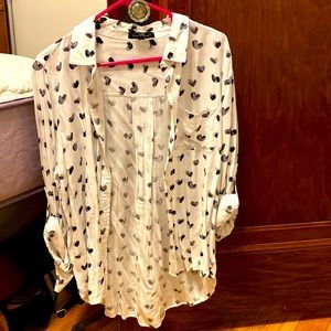 This white blouse with black hearts. The brand is velvet heart!